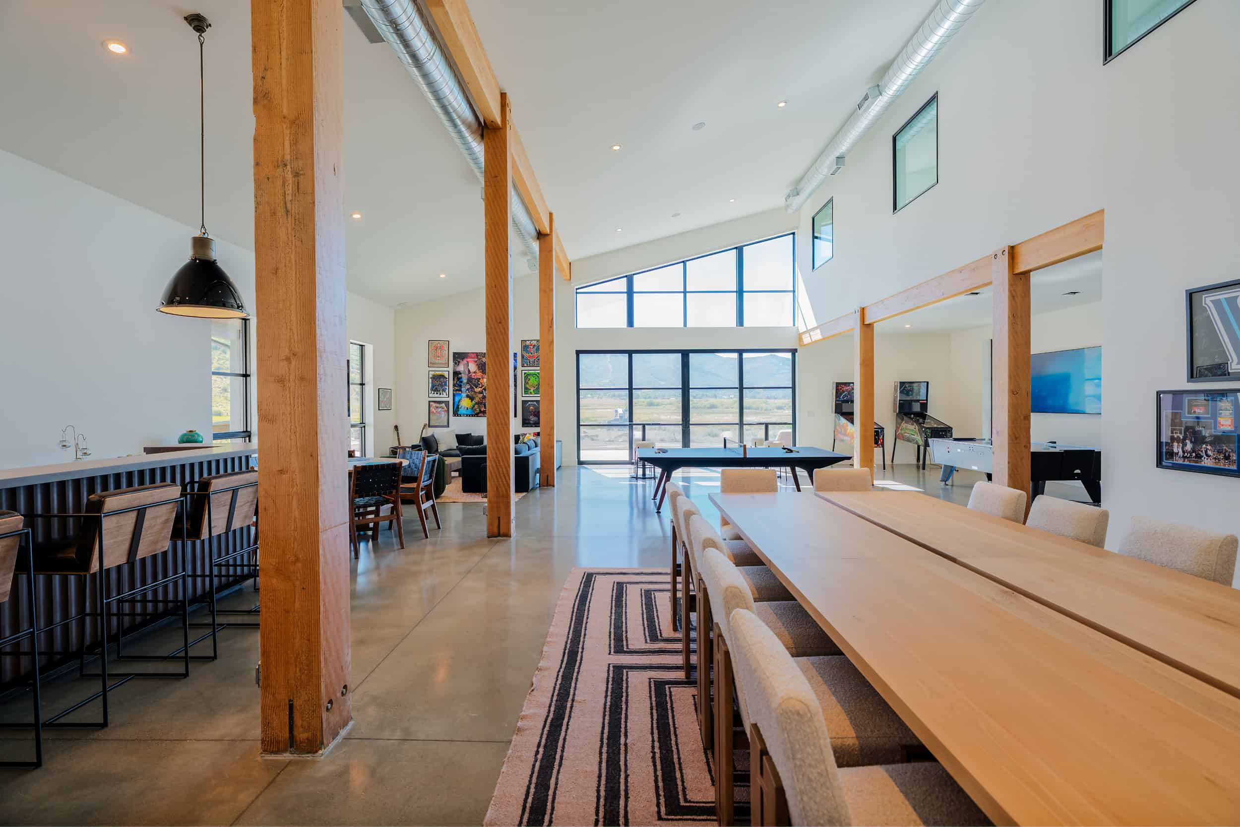 Modern, spacious entertainment space with gaming stations, pool table, and modern design.