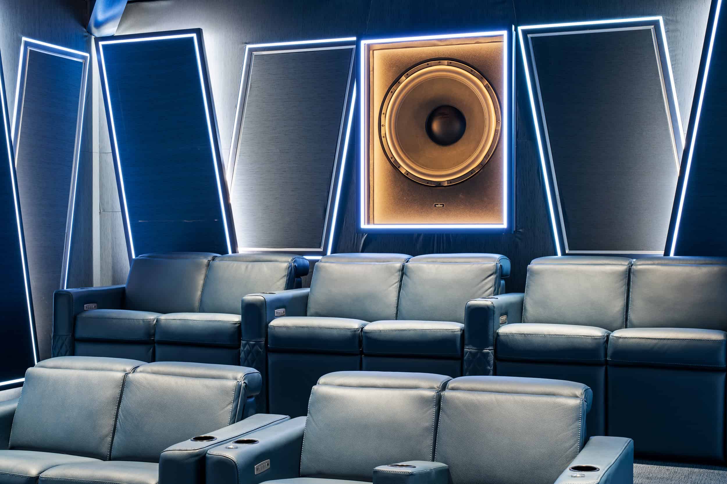 Luxury cinema seating with ambient LED lighting and professional sound system.